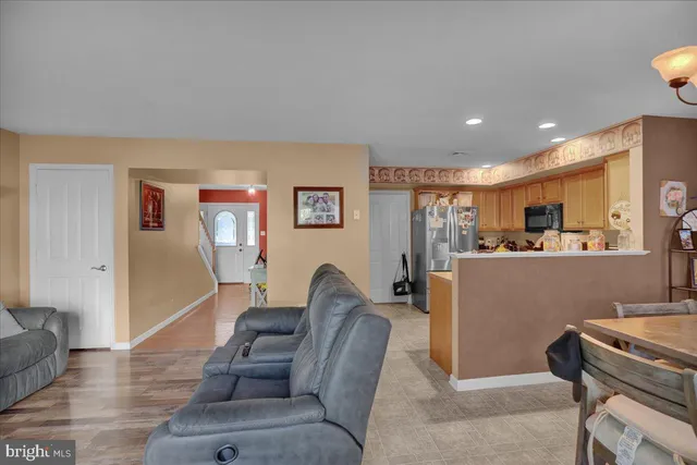 a living room with furniture and kitchen view