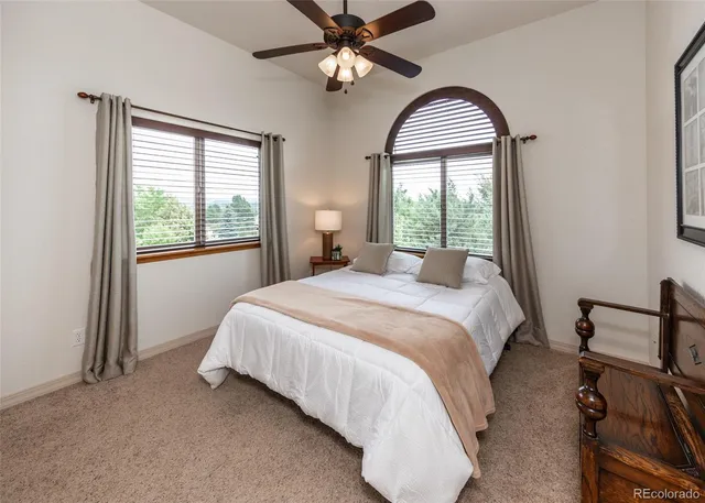 a bedroom with a bed and a large window