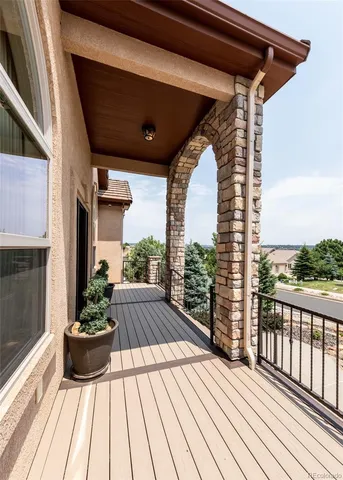 a view of balcony with wooden floor and outdoor seating