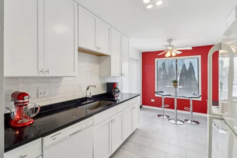 a kitchen with a refrigerator and a sink