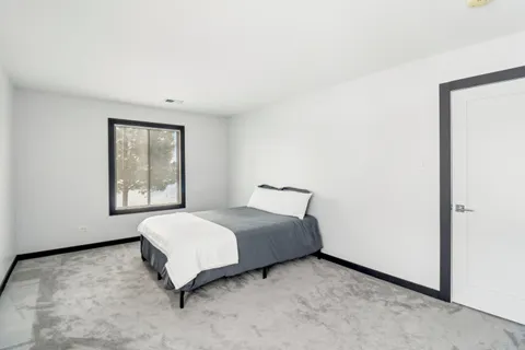 a bedroom with a bed and window