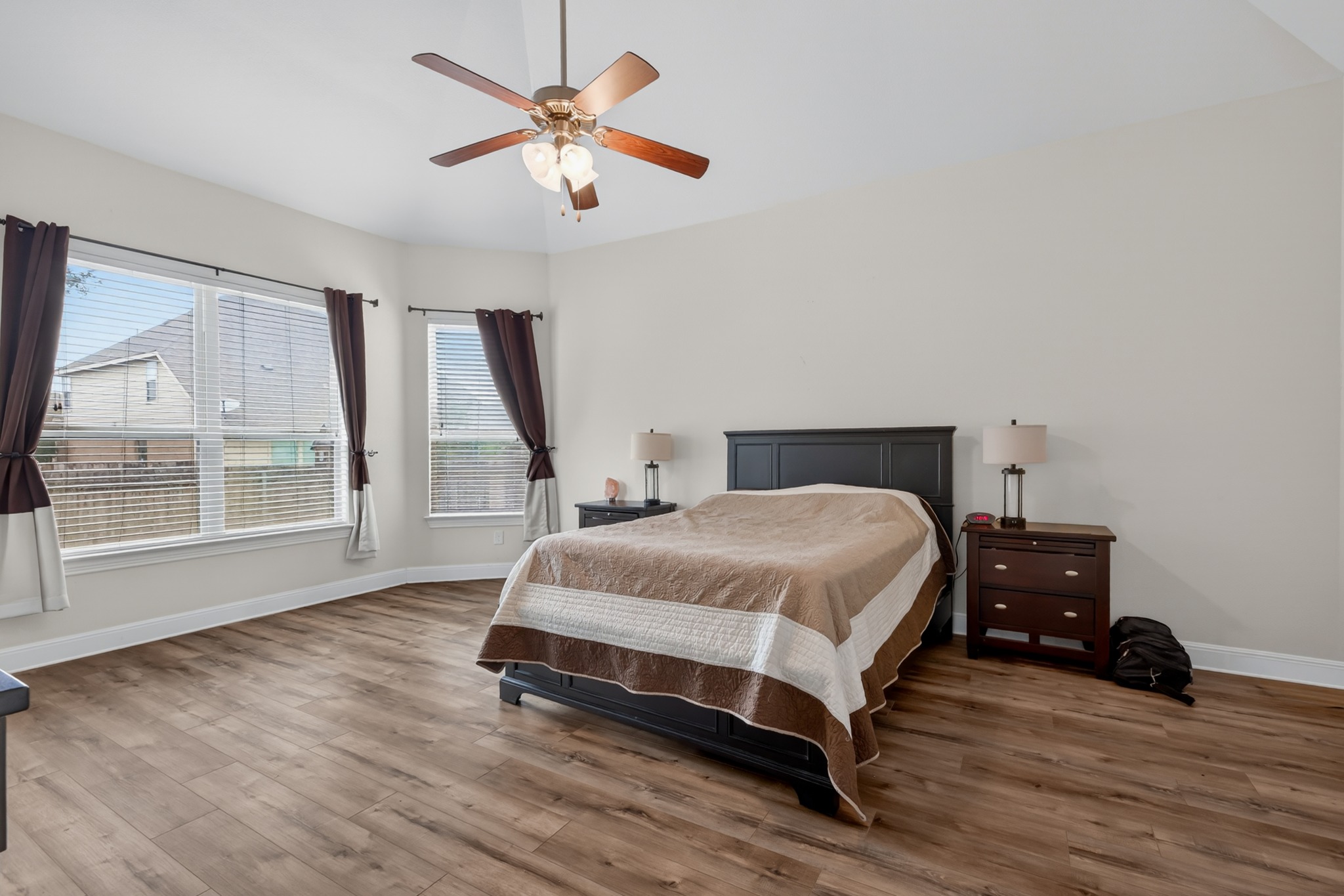 1017 Tabernash Leander, TX 78641 - Photo 20 of 38 Spacious bedroom featuring wood-finish flooring, a vaulted ceiling, and a ceiling fan with integrated lighting