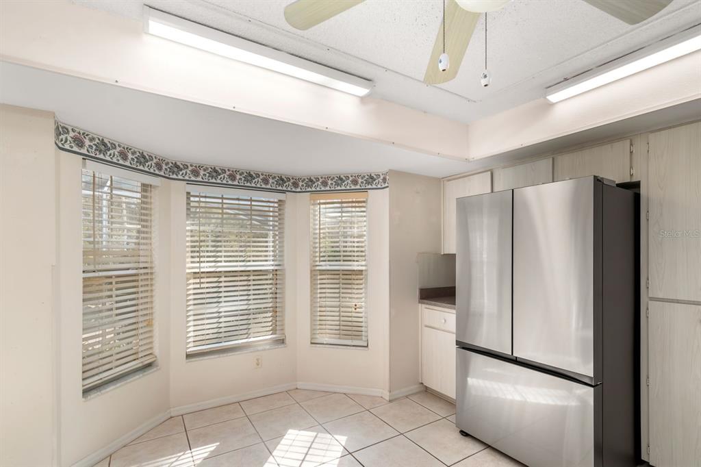10795 Southwest 53rd Circle Ocala, FL 34476 - Photo 19 of 47 a view of a refrigerator in kitchen and an empty room