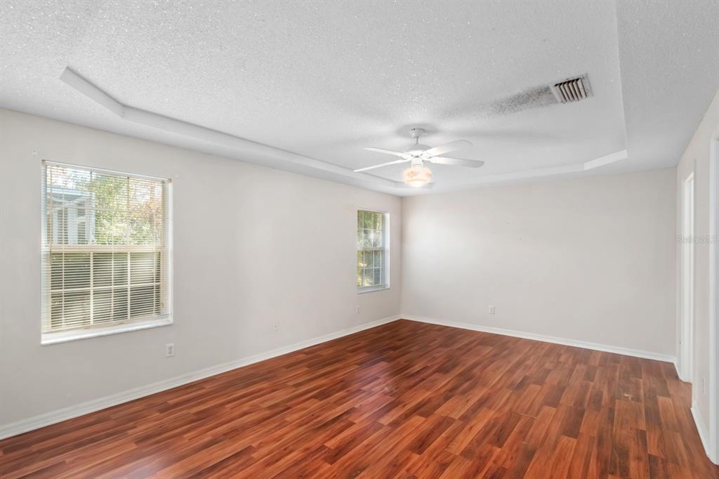 10795 Southwest 53rd Circle Ocala, FL 34476 - Photo 21 of 47 a view of empty room with wooden floor and fan