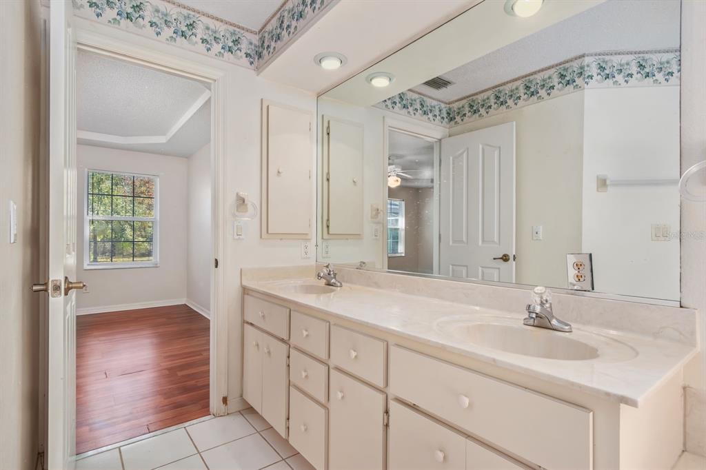10795 Southwest 53rd Circle Ocala, FL 34476 - Photo 26 of 47 a bathroom with a sink and a mirror