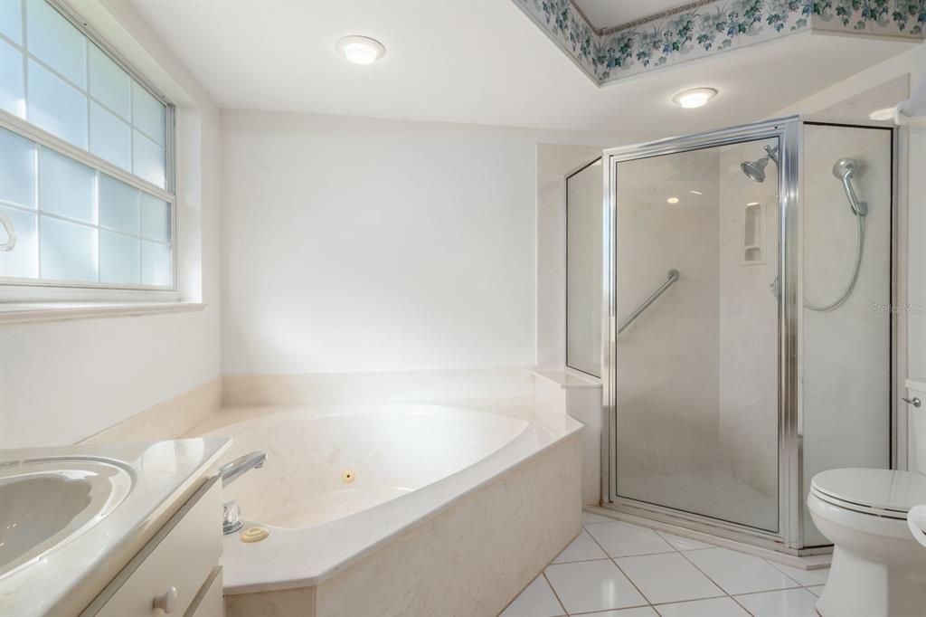 10795 Southwest 53rd Circle Ocala, FL 34476 - Photo 27 of 47 a white bath tub sitting next to a toilet