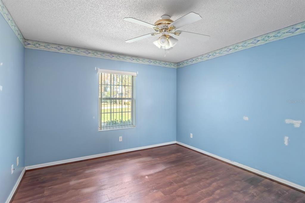 10795 Southwest 53rd Circle Ocala, FL 34476 - Photo 33 of 47 an empty room with windows and ceiling fan