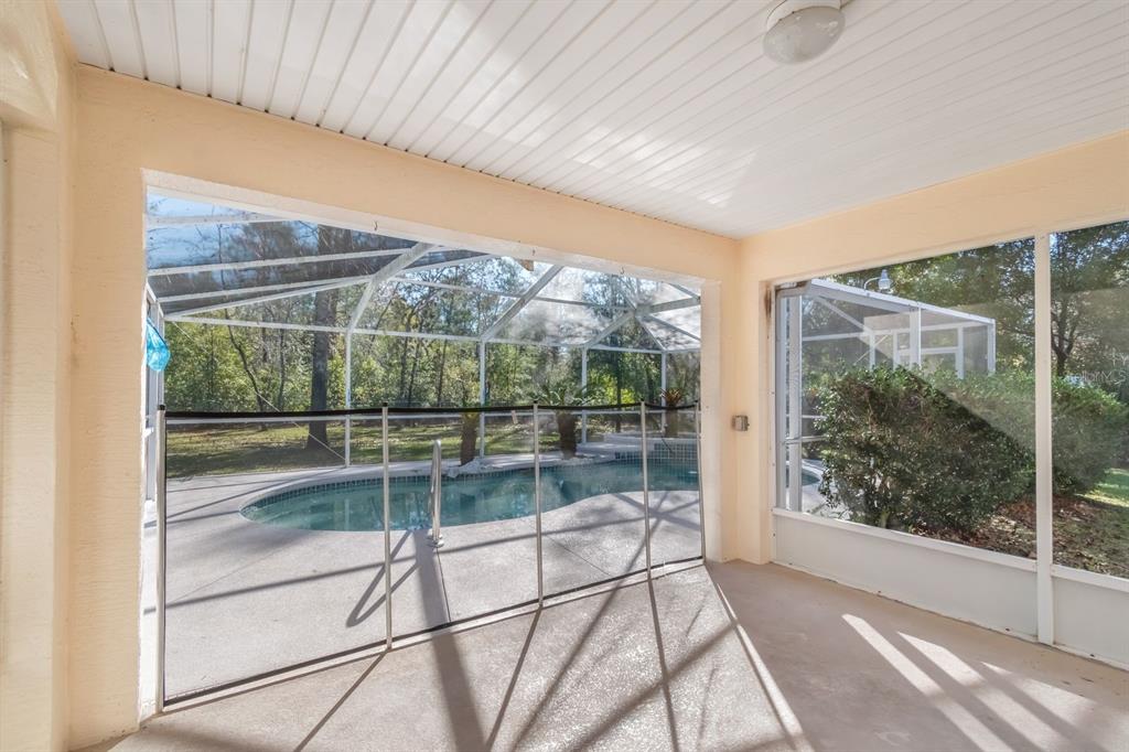 10795 Southwest 53rd Circle Ocala, FL 34476 - Photo 35 of 47 a view of a room with a large window and wooden floor