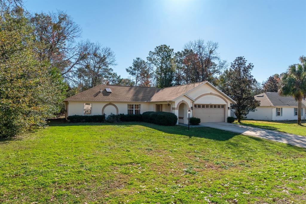 10795 Southwest 53rd Circle Ocala, FL 34476 - Photo 4 of 47 a front view of a house with yard and green space