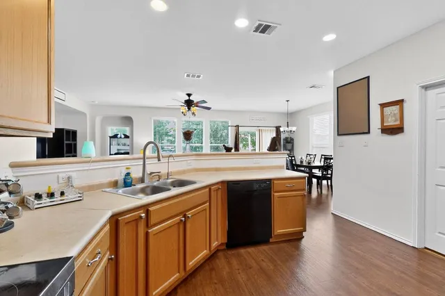 a kitchen with stainless steel appliances granite countertop a refrigerator and a stove top oven