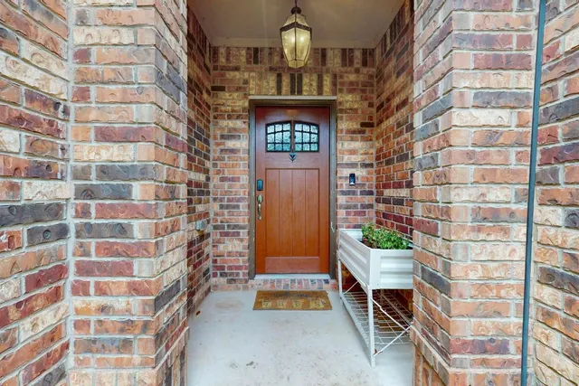 front view of house with a yard and potted plants