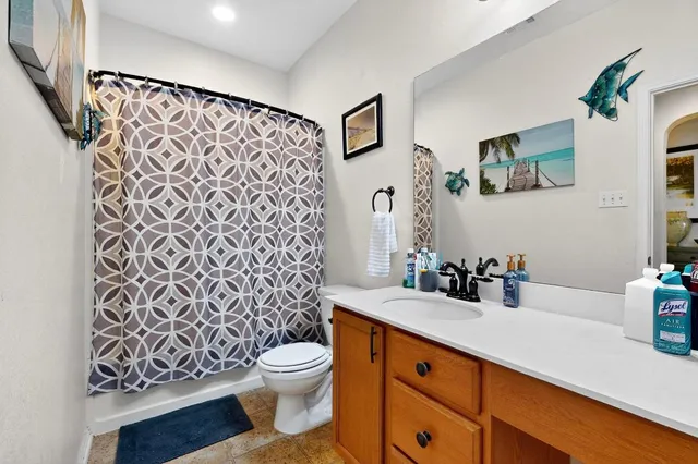 a bathroom with a sink a toilet and mirror