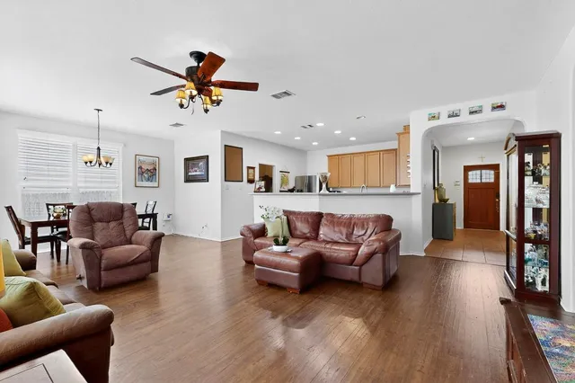 a living room with furniture a fireplace and a large window