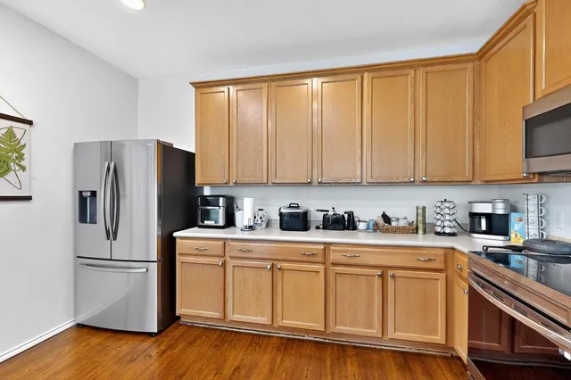 a kitchen with stainless steel appliances granite countertop a stove sink and cabinets