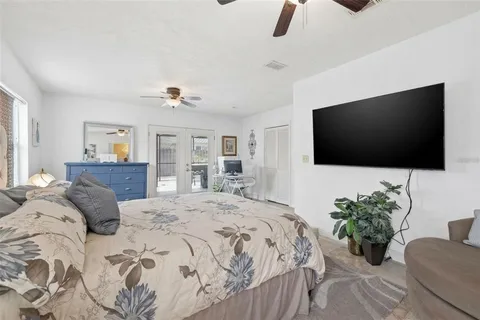a bedroom with a bed and a flat screen tv