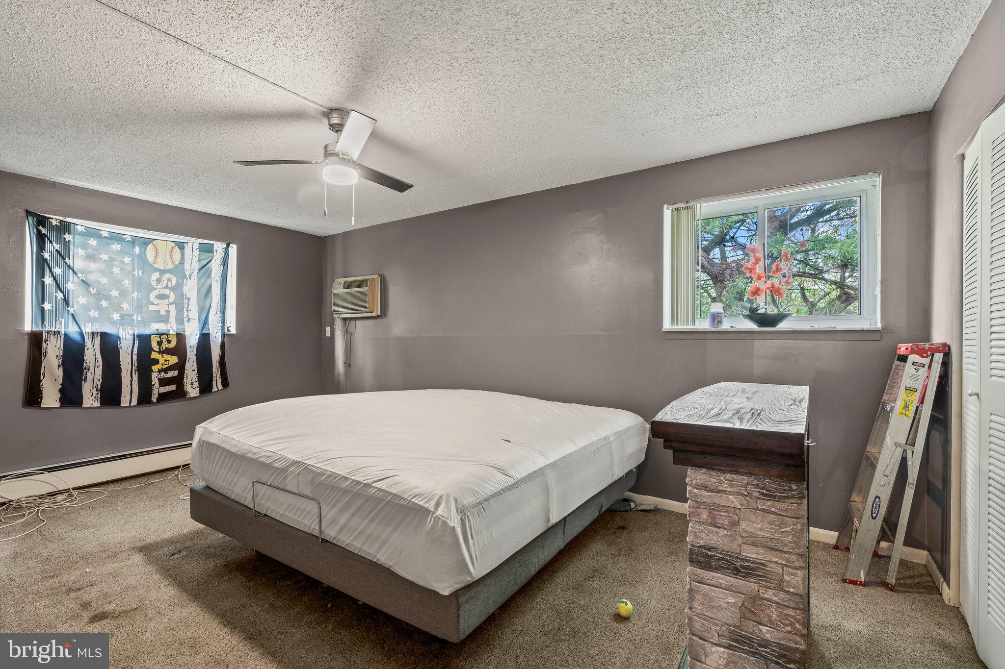400 Glendale Road, Unit D51 Havertown, PA 19083 - Photo 13 of 17 a bedroom with a bed and a painting on the wall
