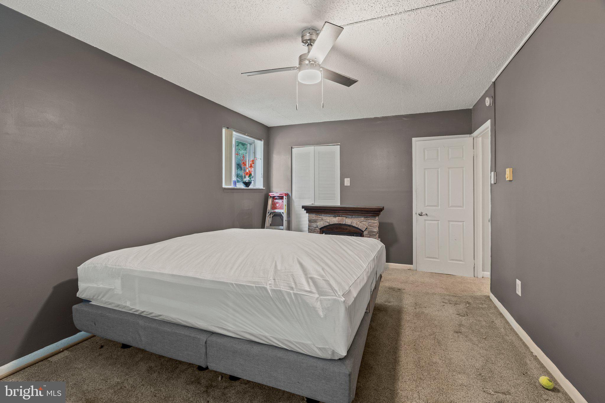 400 Glendale Road, Unit D51 Havertown, PA 19083 - Photo 14 of 17 a bedroom with a bed and a chandelier