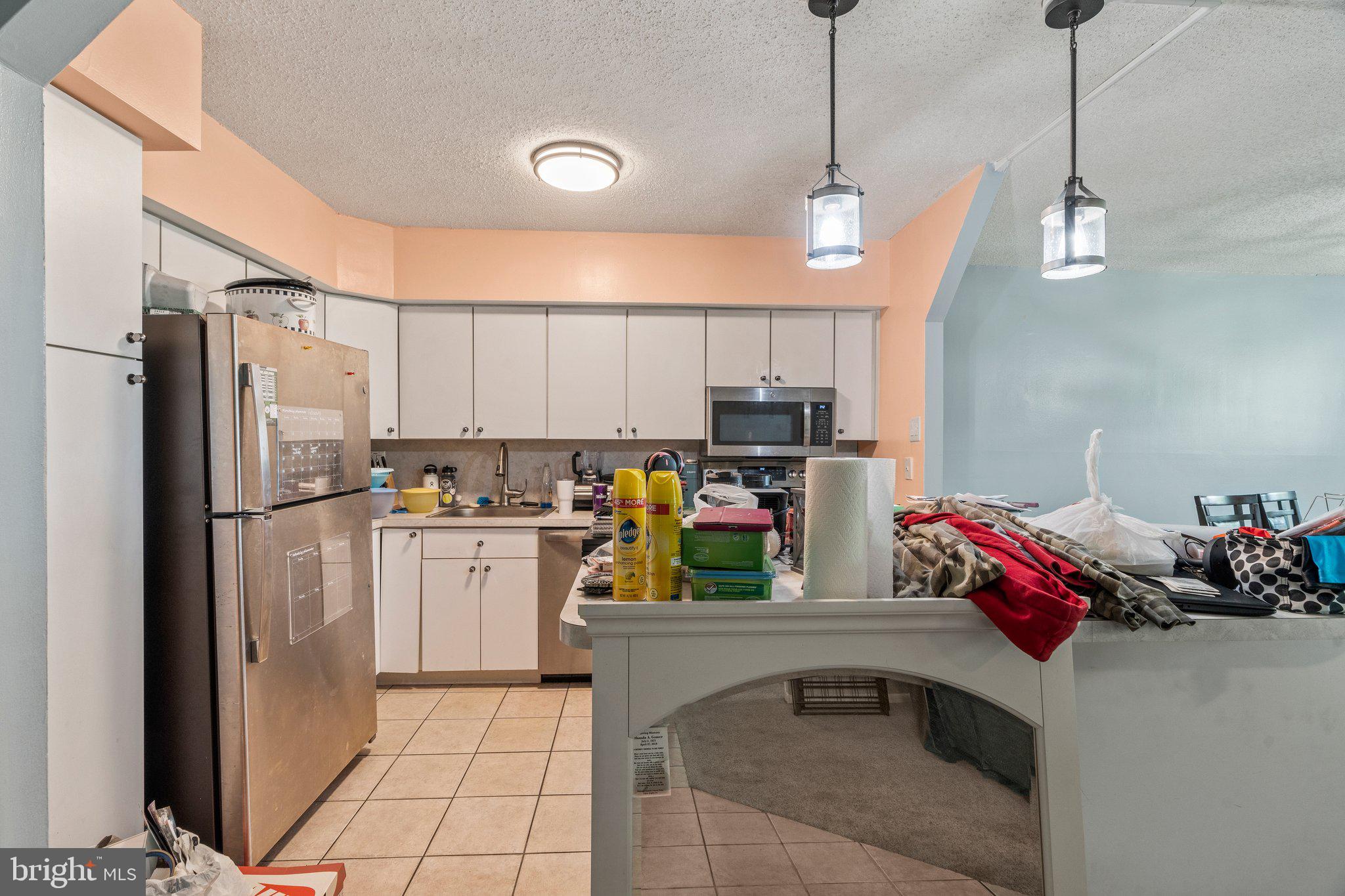 400 Glendale Road, Unit D51 Havertown, PA 19083 - Photo 4 of 17 a kitchen with stainless steel appliances granite countertop a refrigerator a stove and a sink