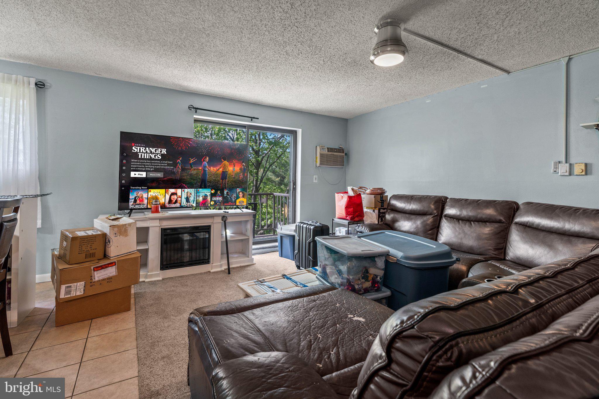 400 Glendale Road, Unit D51 Havertown, PA 19083 - Photo 6 of 17 a living room with furniture a fireplace and a flat screen tv