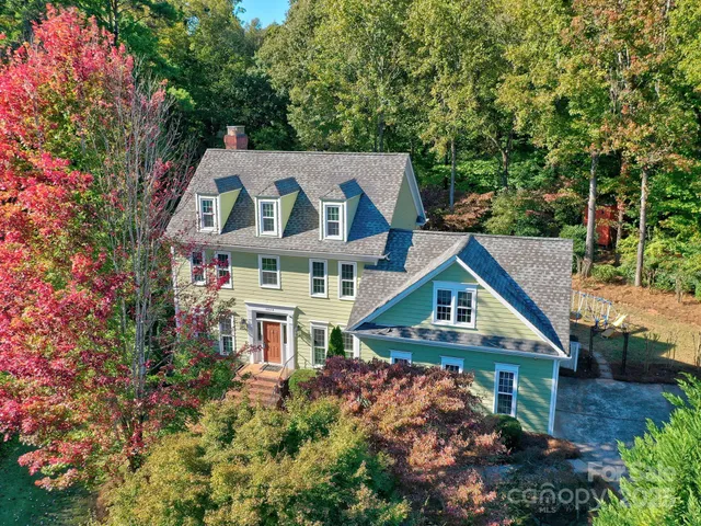 an aerial view of a house with a big yard