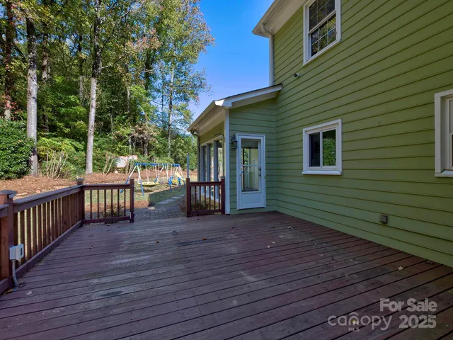 a view of a house with wooden deck