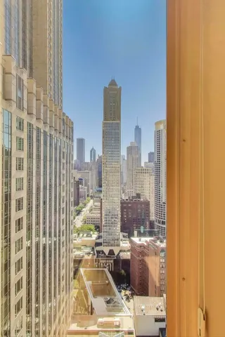 a living room with furniture and a dining table with wooden floor