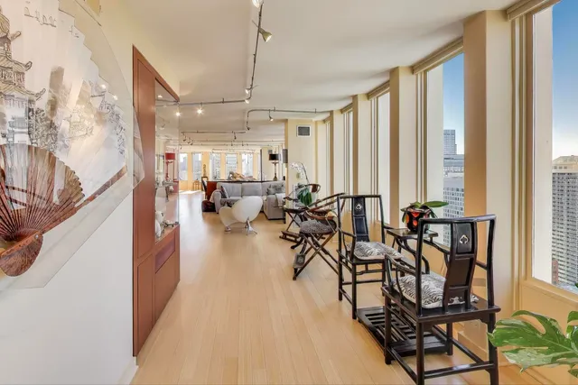 a kitchen with stainless steel appliances granite countertop a table chairs and a refrigerator