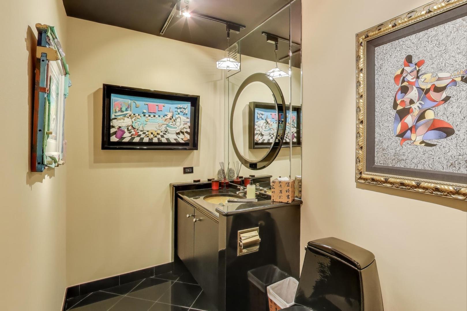 100 East Walton Street, Unit 42F Chicago, IL 60611 - Photo 25 of 50 a bathroom with a toilet a sink and a mirror