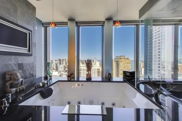 a living room with furniture and large windows