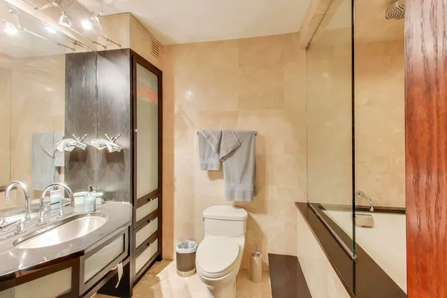 a bedroom with furniture and large windows