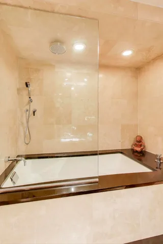 a bedroom with furniture and large windows