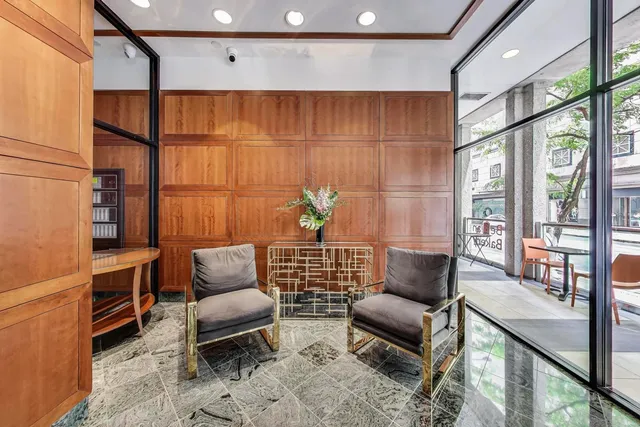 a living room with furniture a rug and a window