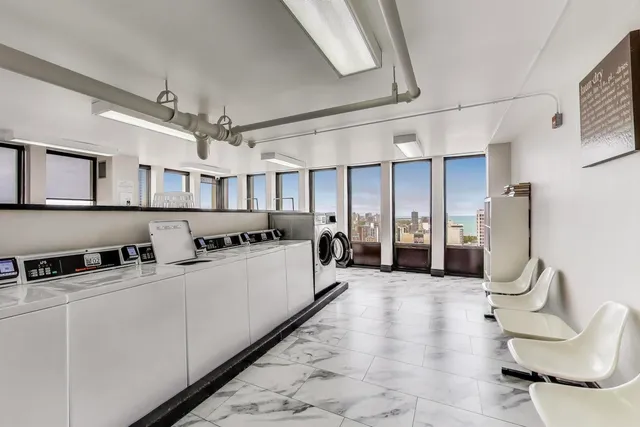 a view of staircase with lots of frames and chairs