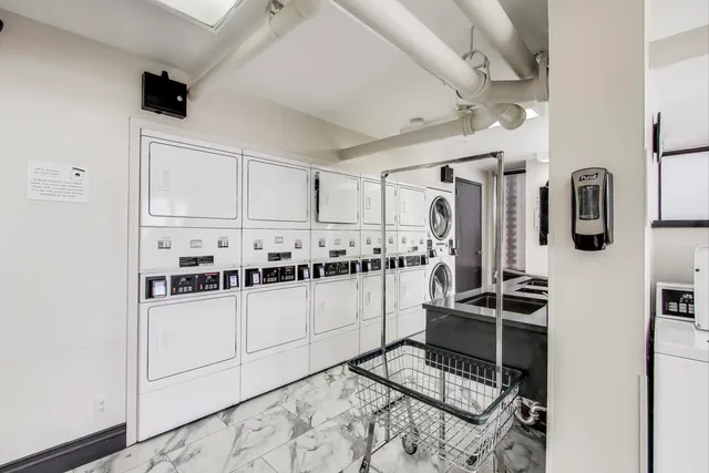 a view of a patio with table and chairs potted plants and wooden fence