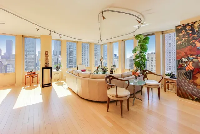 a view of a hallway with a livingroom and a livingroom with furniture