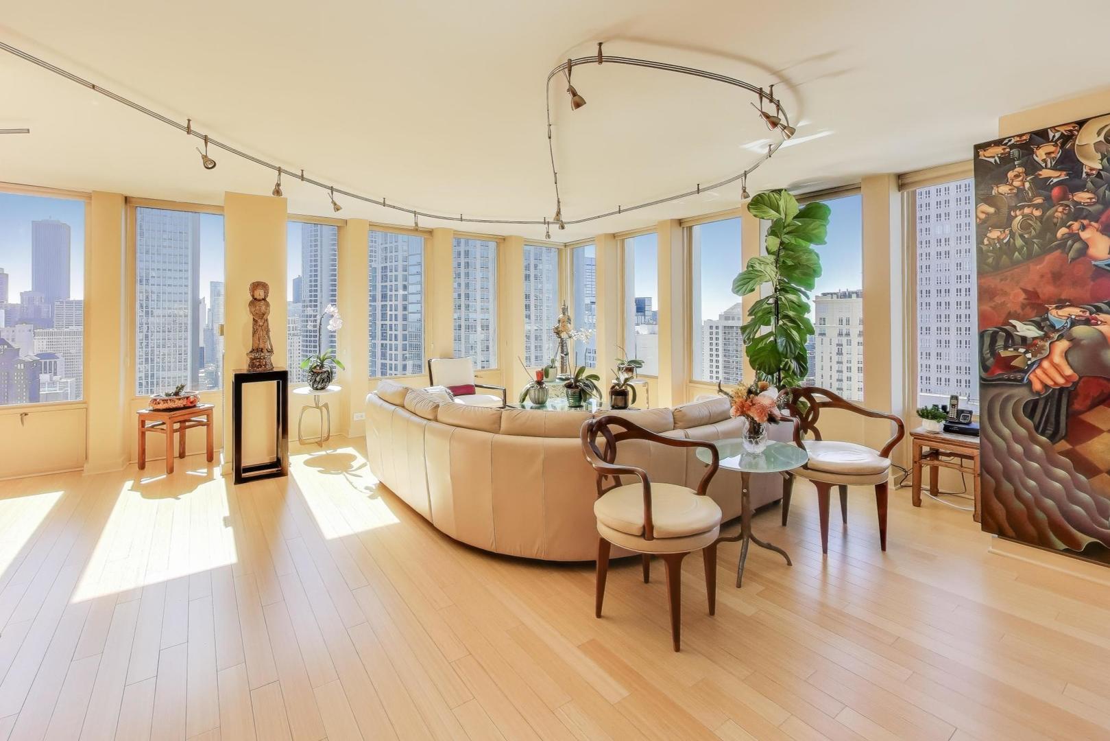 100 East Walton Street, Unit 42F Chicago, IL 60611 - Photo 6 of 50 a living room with furniture a flat screen tv and a large window