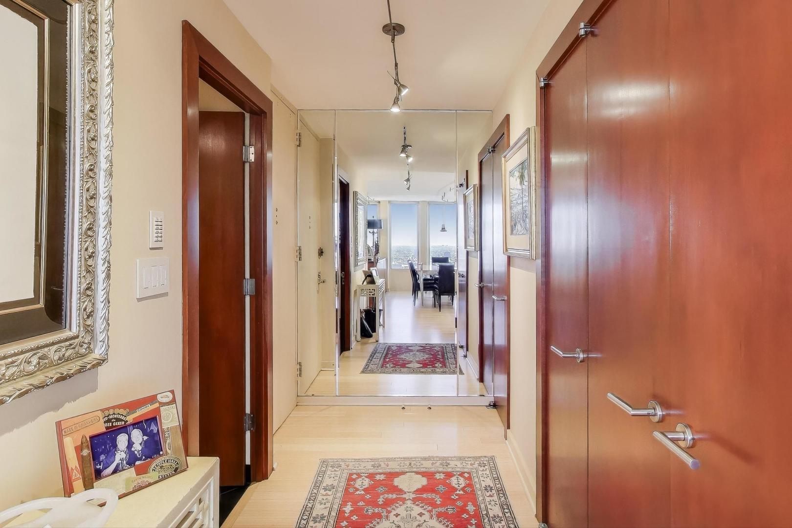 100 East Walton Street, Unit 42F Chicago, IL 60611 - Photo 7 of 50 a view of a hallway with a livingroom and a livingroom with furniture