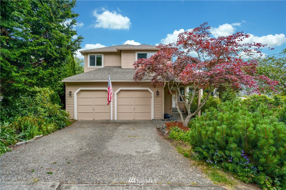 527 224 Place Southeast Bothell, WA 98021 - Photo 1 of 23 a front view of a house with a yard and garage