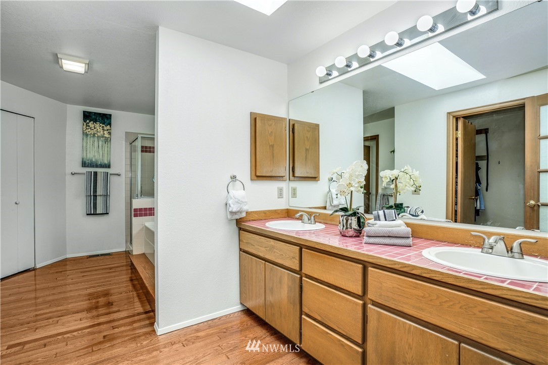 527 224 Place Southeast Bothell, WA 98021 - Photo 13 of 23 a bathroom with a granite countertop sink and a mirror
