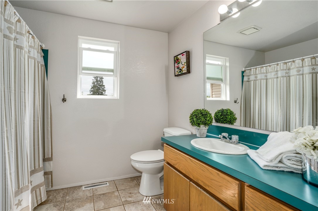 527 224 Place Southeast Bothell, WA 98021 - Photo 17 of 23 a bathroom with a granite countertop sink and a mirror
