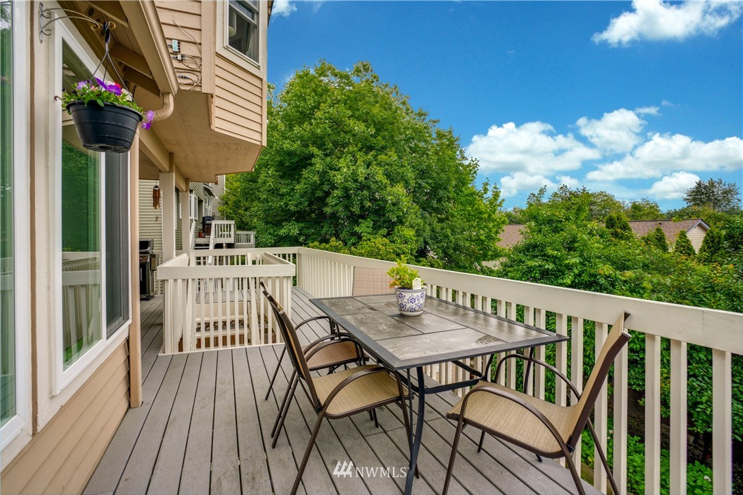 527 224 Place Southeast Bothell, WA 98021 - Photo 19 of 23 a view of balcony with wooden floor and outdoor seating