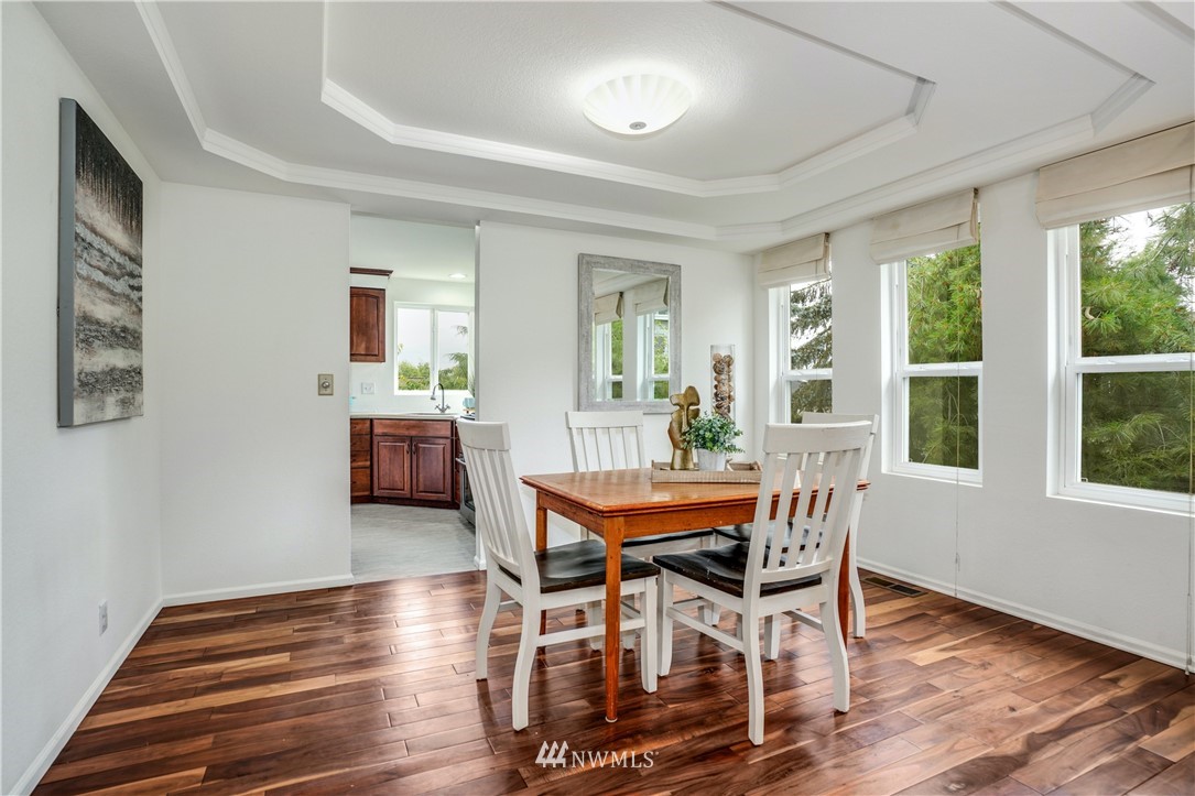 527 224 Place Southeast Bothell, WA 98021 - Photo 3 of 23 a dining room with furniture and wooden floor
