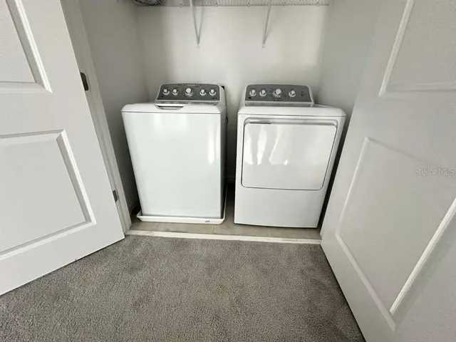 a view of storage and utility room with washer and dryer
