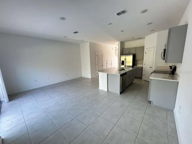a view of a kitchen with microwave and cabinets
