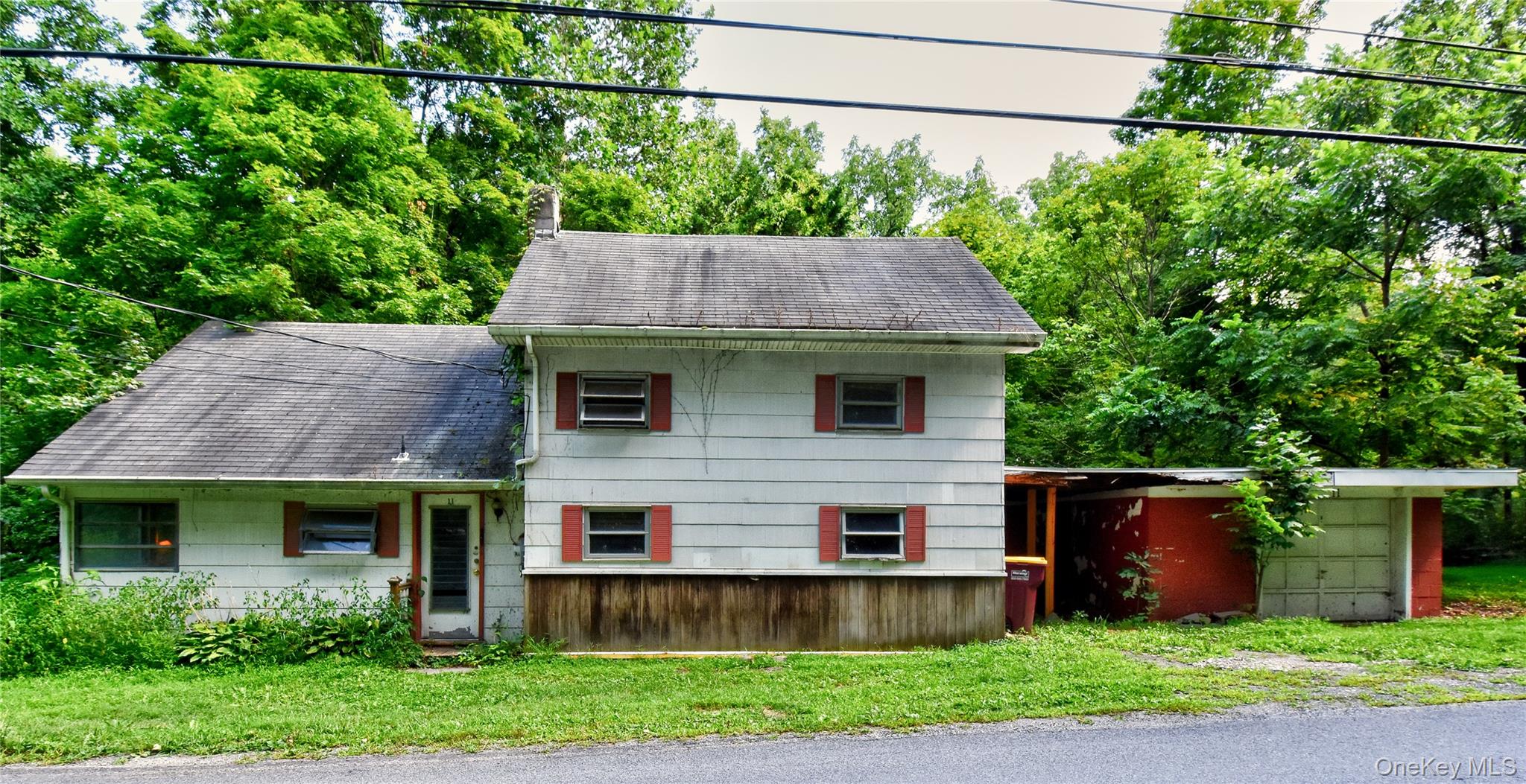 a front view of house with a yard and a garden