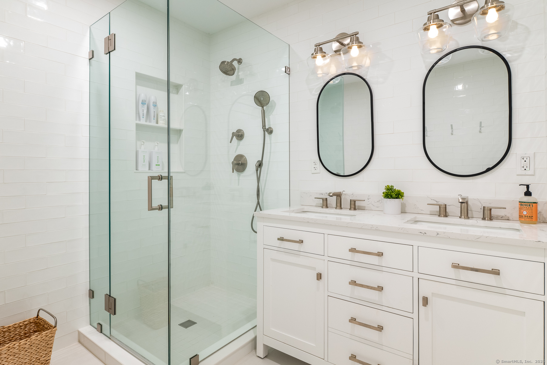 12 Libby Lane Darien, CT 06820 - Photo 19 of 36 a bathroom with double vanity sinks and a mirror