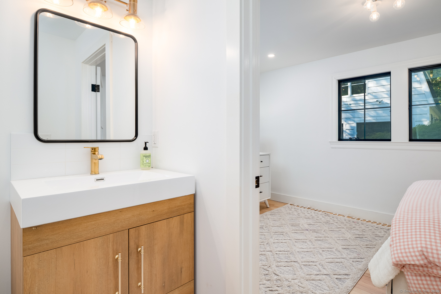 12 Libby Lane Darien, CT 06820 - Photo 20 of 36 a bathroom with a sink vanity and a mirror