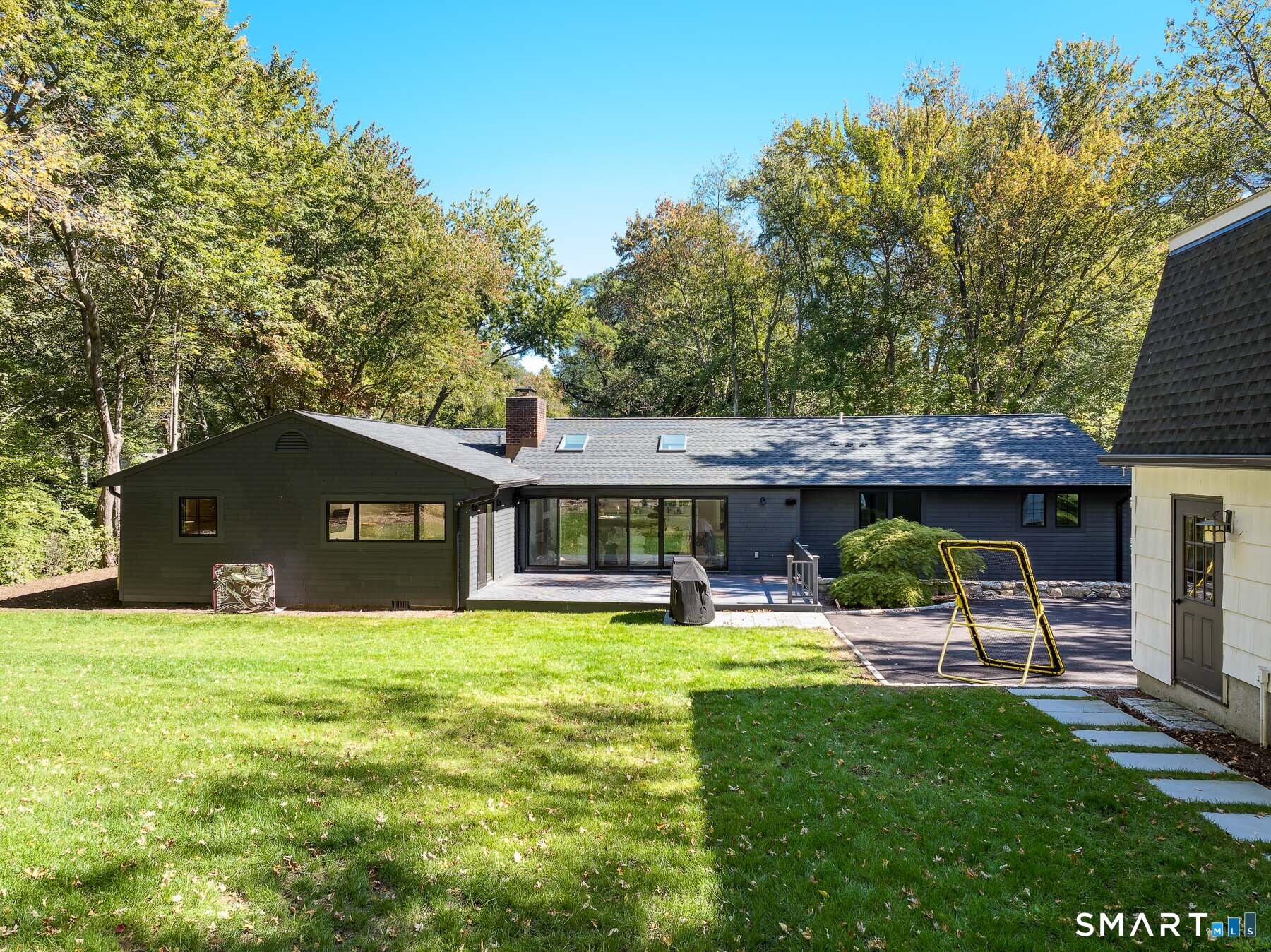 12 Libby Lane Darien, CT 06820 - Photo 25 of 36 a view of a house with a yard and sitting area