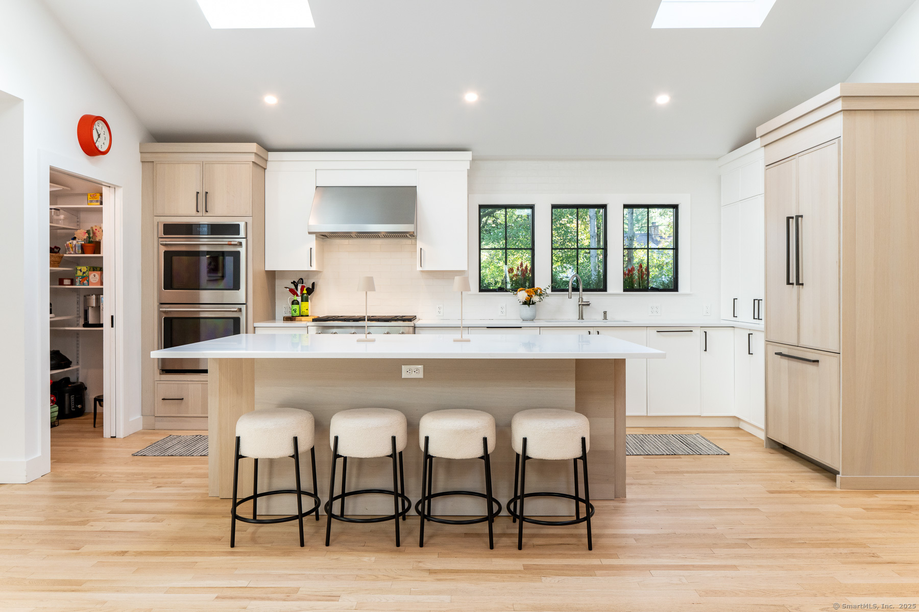 12 Libby Lane Darien, CT 06820 - Photo 5 of 36 a kitchen with stainless steel appliances granite countertop a table chairs sink and cabinets