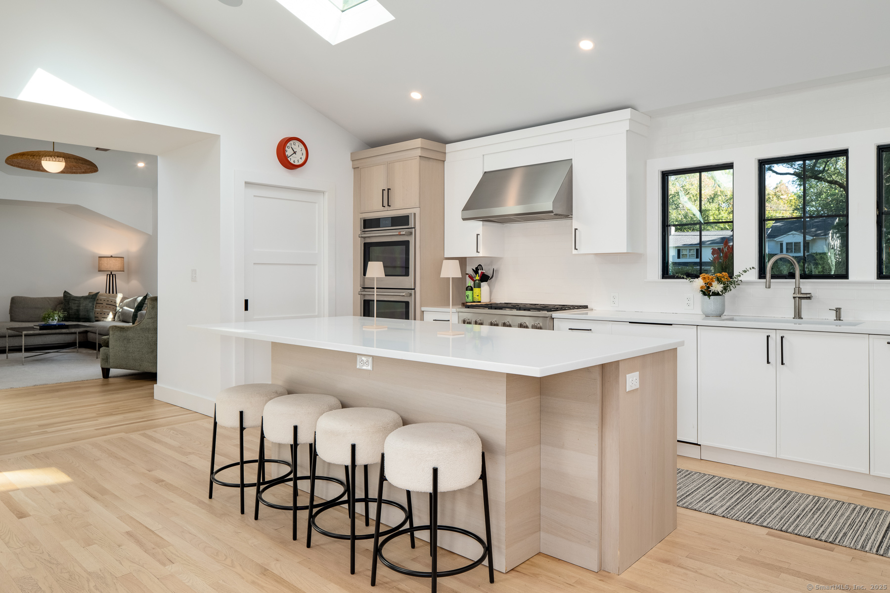 12 Libby Lane Darien, CT 06820 - Photo 6 of 36 a kitchen with white cabinets and chairs